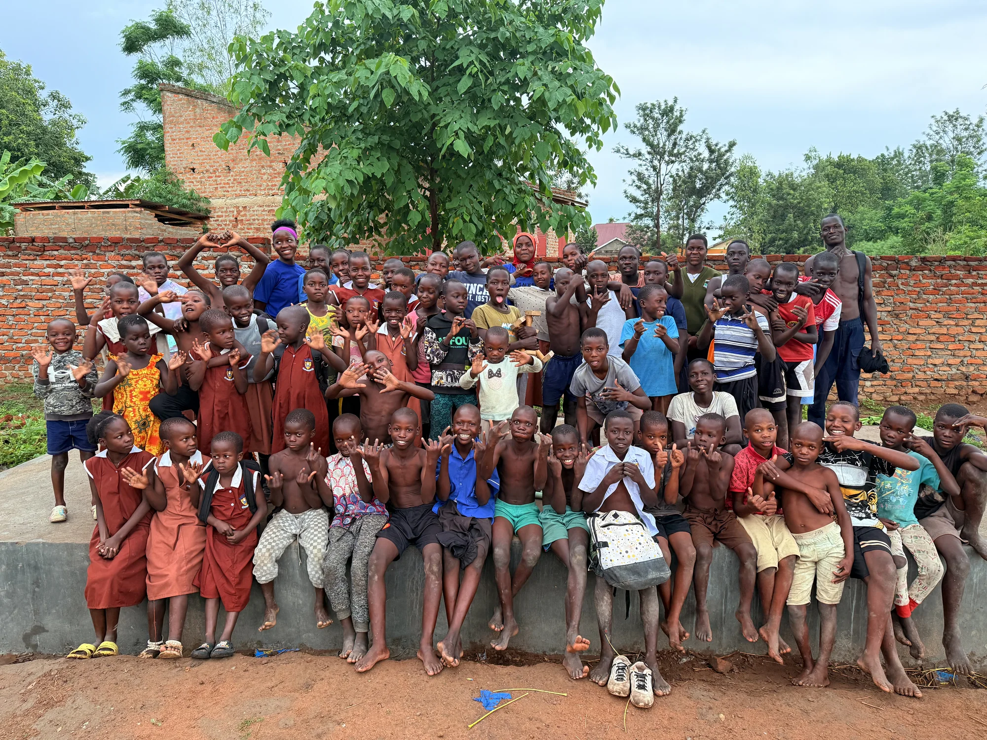 The Clon Circus Uganda community gathers for a group photograph at the training ground.