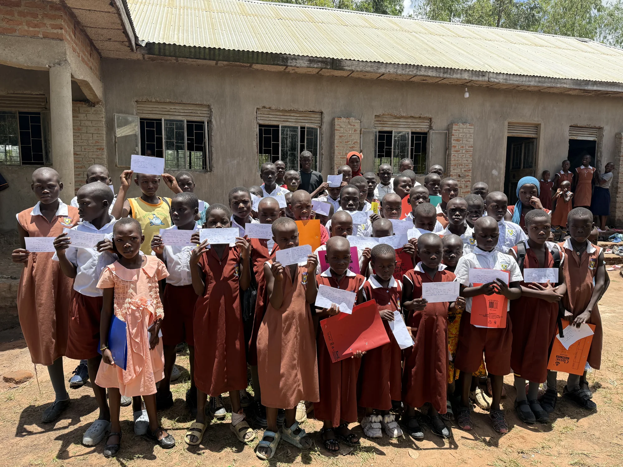 Clon Circus Uganda children receiving school materials
